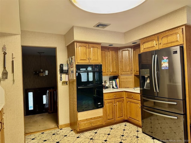 62 Rte 6n Rte, Carmel, NY 10541 - kitchen featuring stainless steel fridge, dobule oven black, brown cabinetry, and visible vents