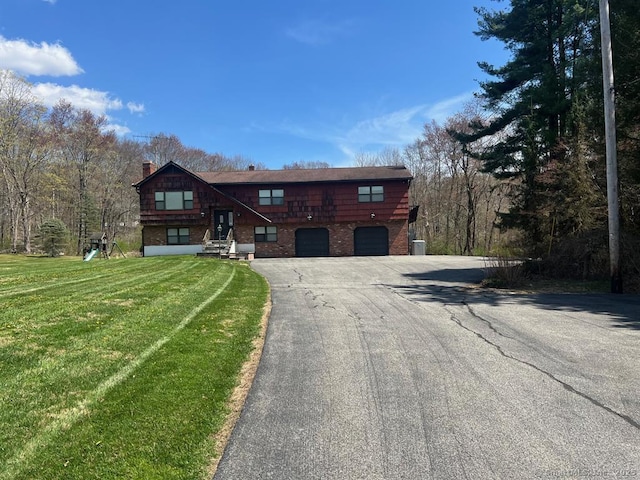 62 Rte 6n Rte, Carmel, NY 10541 - log-style house with a front lawn, a chimney, brick siding, an attached garage, and driveway