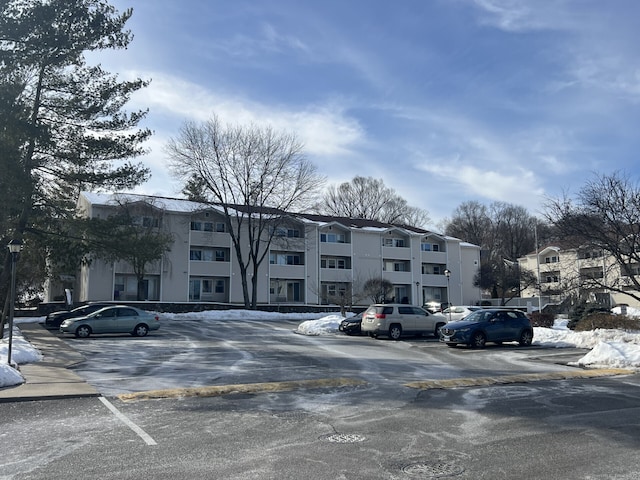 view of building exterior featuring uncovered parking