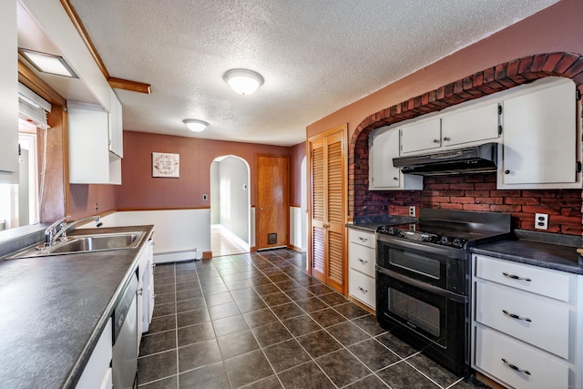 kitchen featuring sink, double oven range, dark tile patterned flooring, white cabinets, and a baseboard heating unit