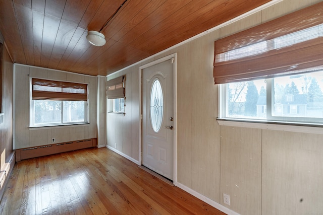 entryway with a healthy amount of sunlight, wooden ceiling, light hardwood / wood-style flooring, and a baseboard heating unit