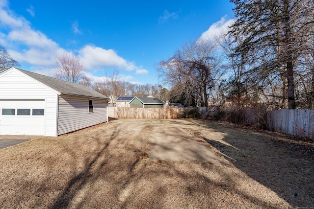 view of yard featuring a garage and an outdoor structure