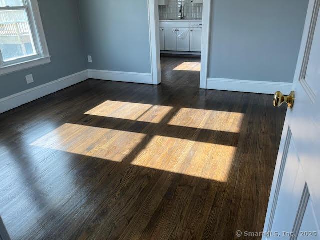 spare room featuring dark hardwood / wood-style flooring