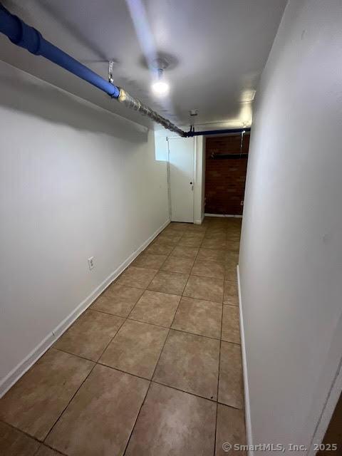 basement featuring light tile patterned floors