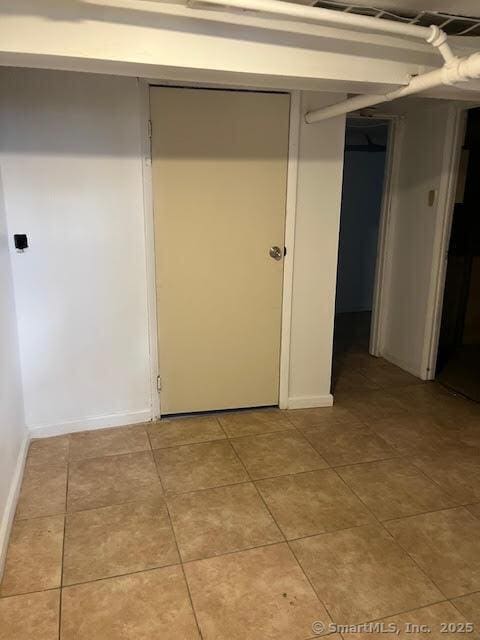 hallway featuring light tile patterned flooring