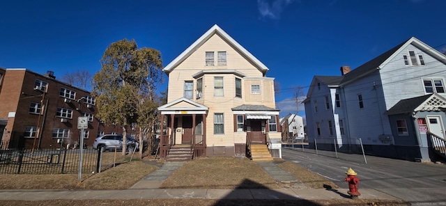 view of front of house featuring fence