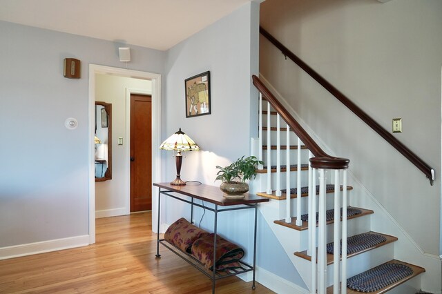 stairs with hardwood / wood-style flooring