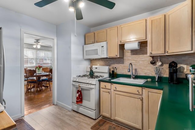 kitchen featuring sink, white appliances, tasteful backsplash, light brown cabinetry, and light wood-type flooring