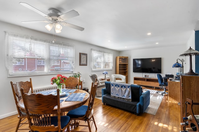 dining space featuring ceiling fan and light wood-type flooring