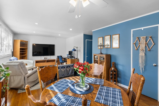 dining space featuring crown molding, hardwood / wood-style floors, and ceiling fan