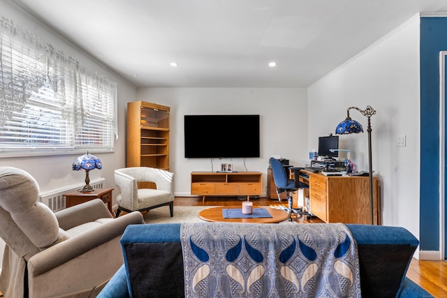 living room with crown molding and hardwood / wood-style floors