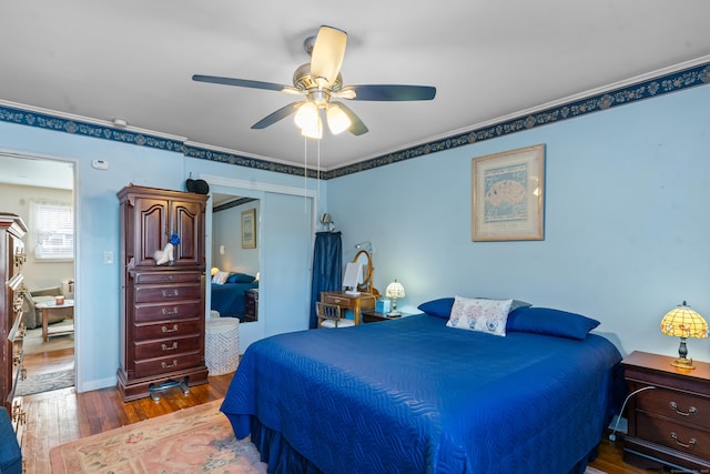 bedroom featuring hardwood / wood-style flooring, ceiling fan, and a closet