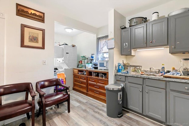 kitchen with sink, gray cabinets, and light hardwood / wood-style floors