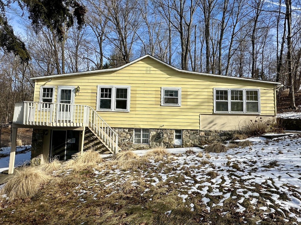 snow covered property featuring a deck