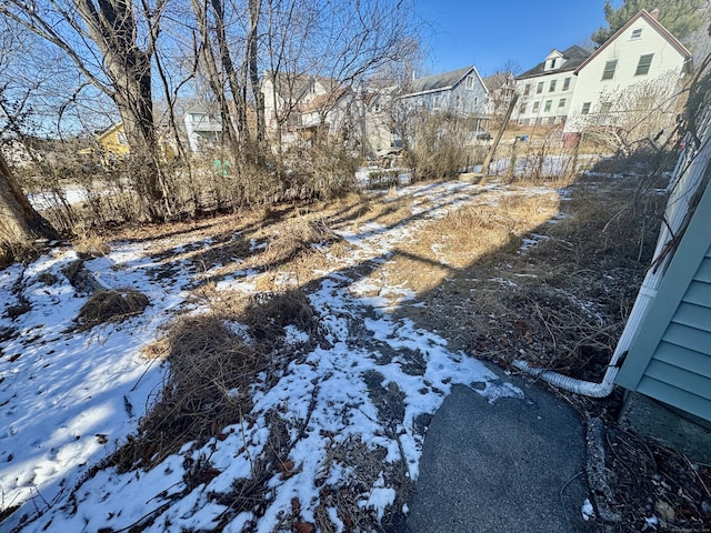 view of yard layered in snow