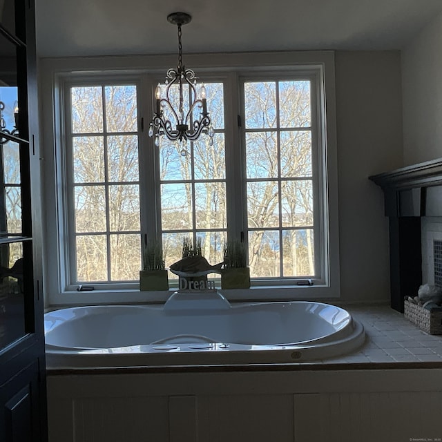 44 Brook St, Groton, CT 06340 - full bathroom featuring a notable chandelier, a tub to relax in, and a wealth of natural light