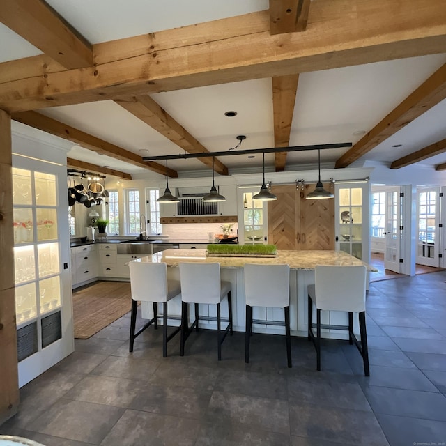 44 Brook St, Groton, CT 06340 - kitchen with plenty of natural light, white cabinets, and french doors