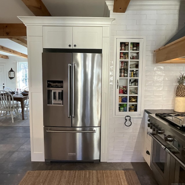 44 Brook St, Groton, CT 06340 - kitchen featuring beamed ceiling, decorative backsplash, range hood, stainless steel appliances, and white cabinetry