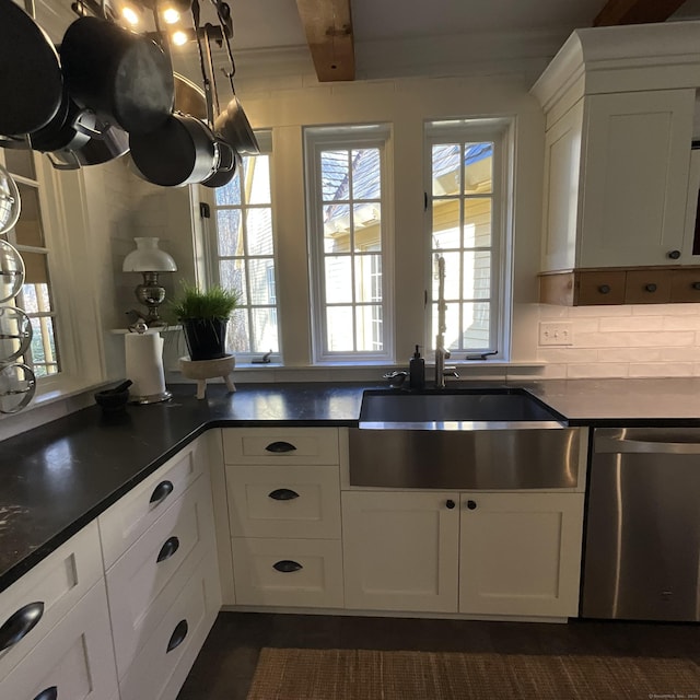 44 Brook St, Groton, CT 06340 - kitchen featuring dark countertops, tasteful backsplash, stainless steel dishwasher, white cabinetry, and a sink