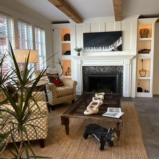 44 Brook St, Groton, CT 06340 - living room featuring a tiled fireplace, beamed ceiling, and built in shelves