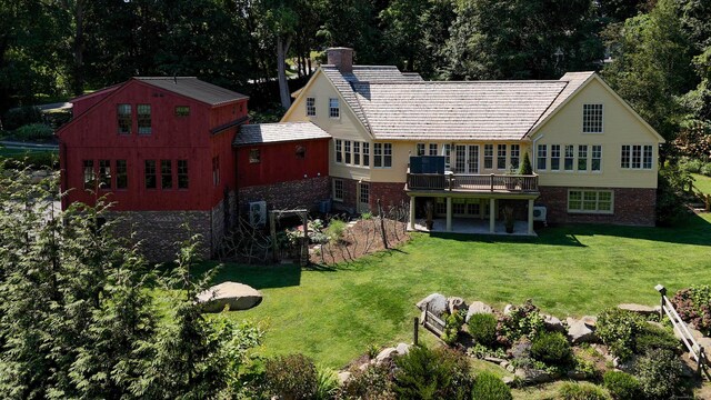 44 Brook St, Groton, CT 06340 - back of house featuring brick siding, a wooden deck, a chimney, a yard, and a patio area