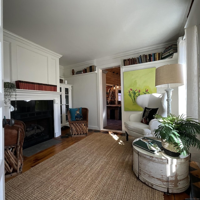 44 Brook St, Groton, CT 06340 - living room with a fireplace with flush hearth, wood finished floors, and crown molding