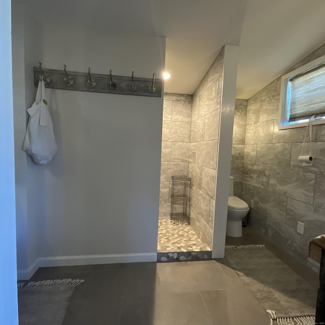 44 Brook St, Groton, CT 06340 - full bath with walk in shower, toilet, lofted ceiling, tile patterned floors, and tile walls