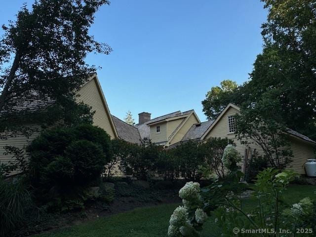 44 Brook St, Groton, CT 06340 - view of property exterior featuring a chimney