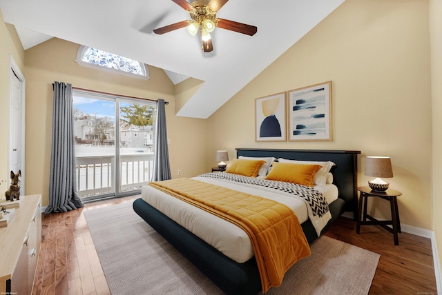 bedroom with lofted ceiling, baseboards, wood finished floors, and access to exterior