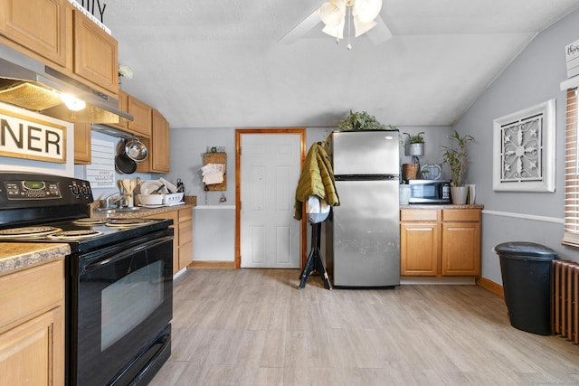 kitchen with stainless steel appliances, lofted ceiling, and light hardwood / wood-style flooring