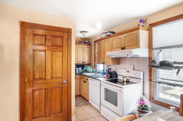 kitchen featuring light tile patterned flooring, sink, light brown cabinets, and white appliances