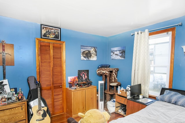 bedroom with multiple windows and wood-type flooring