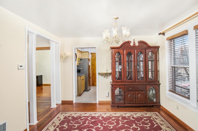 hallway featuring hardwood / wood-style floors and a notable chandelier