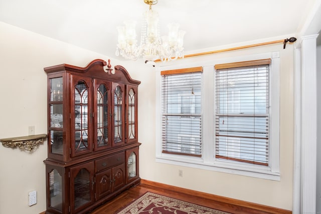 interior space featuring a notable chandelier and hardwood / wood-style flooring