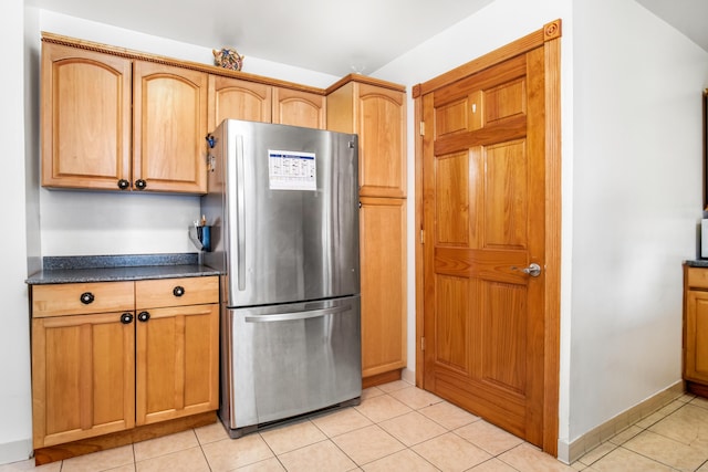 kitchen with stainless steel refrigerator and light tile patterned floors