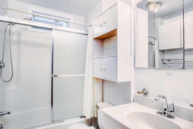 full bathroom featuring vanity, toilet, and combined bath / shower with glass door