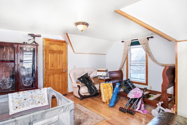 bedroom featuring lofted ceiling and hardwood / wood-style floors