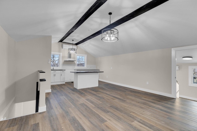 kitchen with dark wood-type flooring, vaulted ceiling with beams, hanging light fixtures, and white cabinets