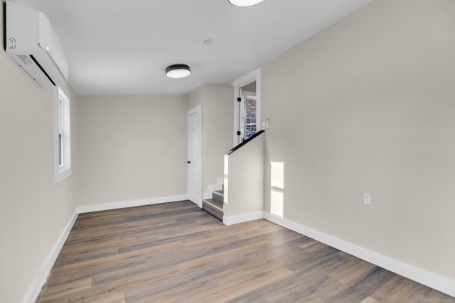 interior space featuring a wall mounted air conditioner and wood-type flooring