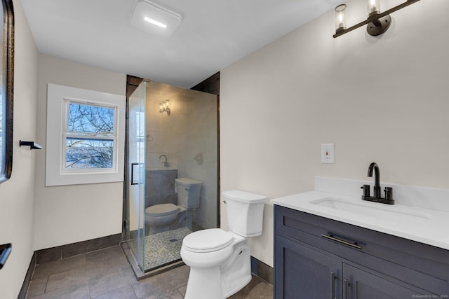 bathroom featuring vanity, a shower with door, and toilet