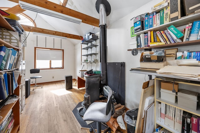 home office featuring light hardwood / wood-style flooring and vaulted ceiling with beams