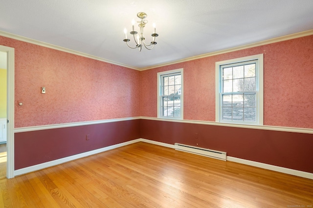 unfurnished room with wood-type flooring, crown molding, a baseboard radiator, and a chandelier