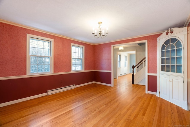 empty room featuring crown molding, a baseboard radiator, an inviting chandelier, and light hardwood / wood-style flooring