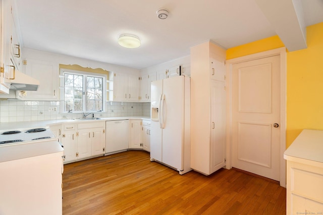 kitchen featuring white cabinetry, white appliances, sink, and light wood-type flooring