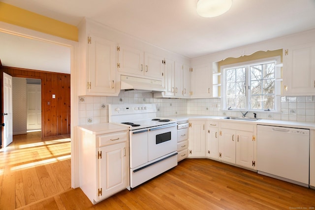 kitchen featuring white appliances, sink, and white cabinets