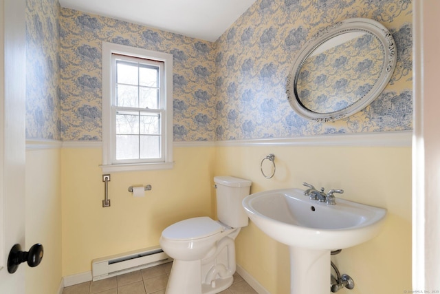 bathroom with tile patterned floors, toilet, and baseboard heating