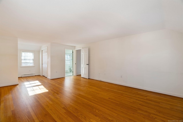 unfurnished room featuring a baseboard radiator and light wood-type flooring