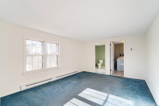 carpeted empty room featuring washer / clothes dryer and a baseboard radiator