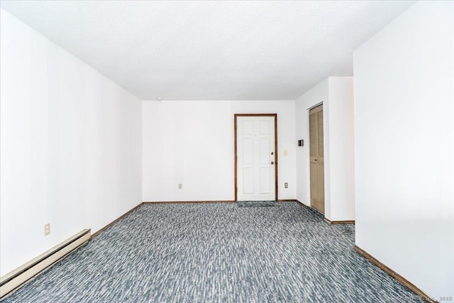 carpeted spare room featuring a baseboard radiator and a textured ceiling