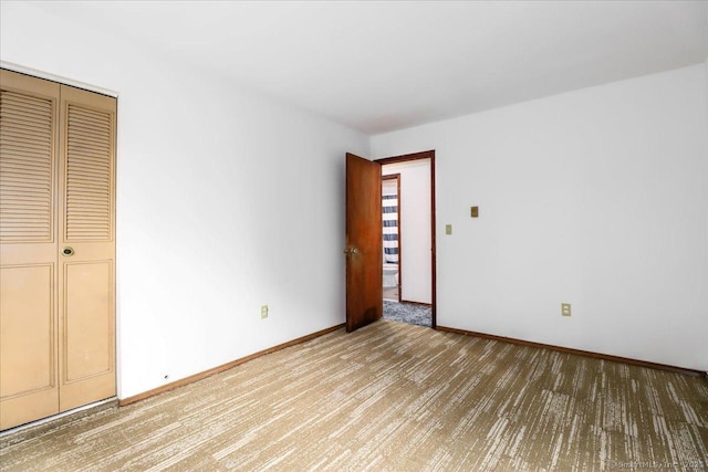 unfurnished bedroom featuring carpet and a closet